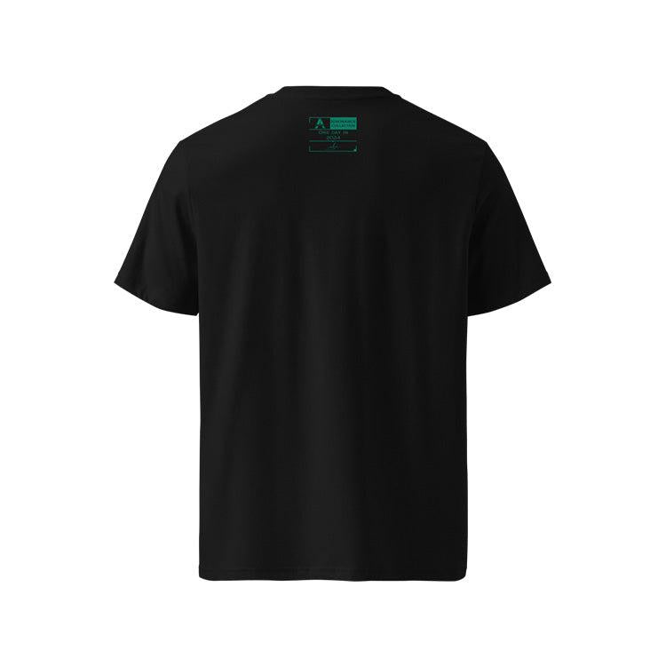 T-shirt unisexe noir, vu de dos et portant l'étiquette de la collection "Ignorance" coloré en vert émeraude